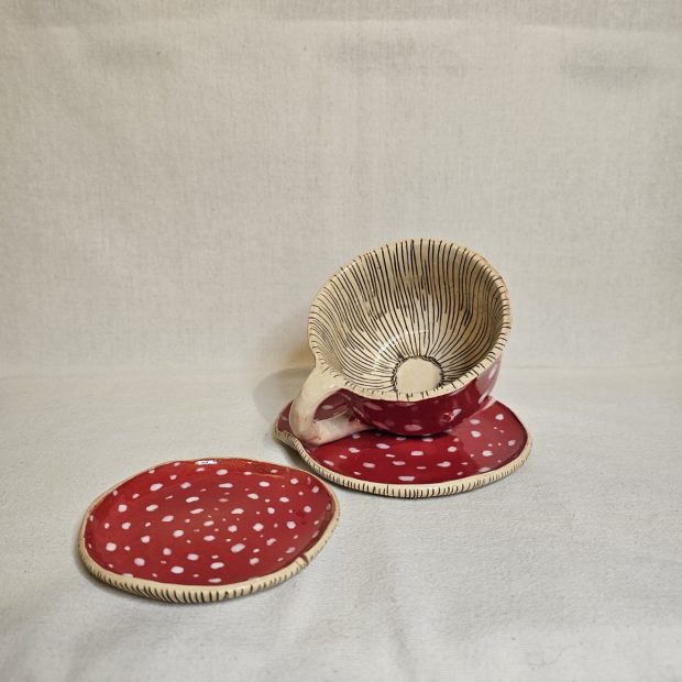 Kubek Muchomor z podstawką i pokrywką obok.