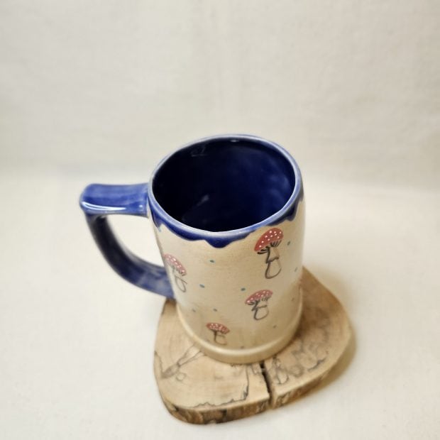 Widok z góry na kufel rękodzielniczy w muchomorki.